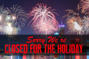Fireworks background in Boston with a black banner at the bottoms which says "Sorry We're Closed for the Holiday" in red letters