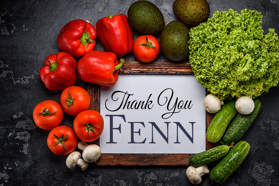 Red and green produce on a dark background with a white board in the middle that says "Thank You Fenn"
