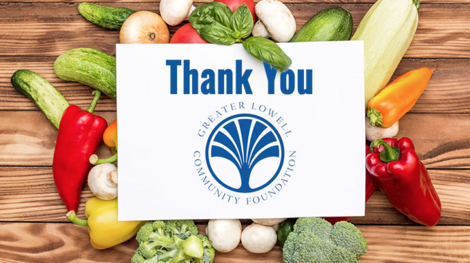 Vegetables on a a cutting board with white center that says Thank You Greater Lowell Community Foundation