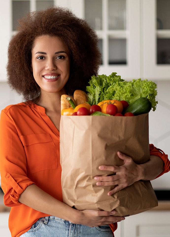 Appeal 2023 Woman in Orange Woman holding bag of groceries