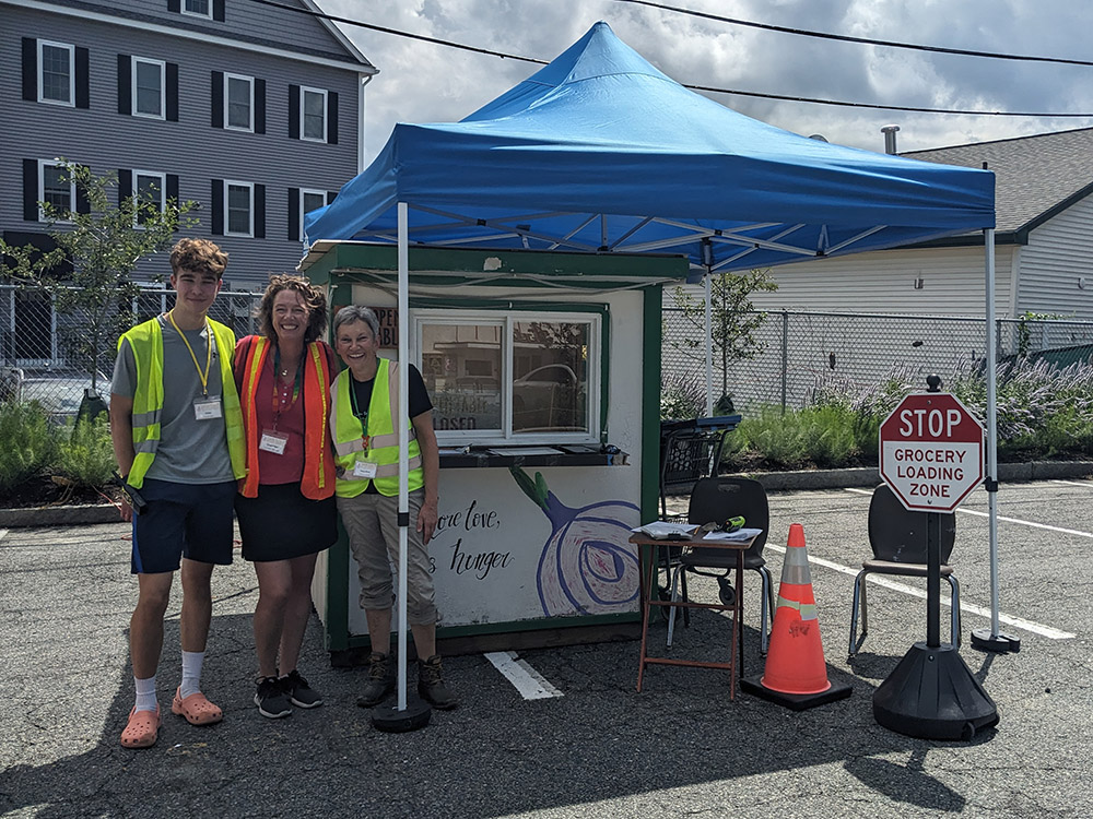 Volunteers waiting to help provide groceries at Open Table's drive-thru pantry
