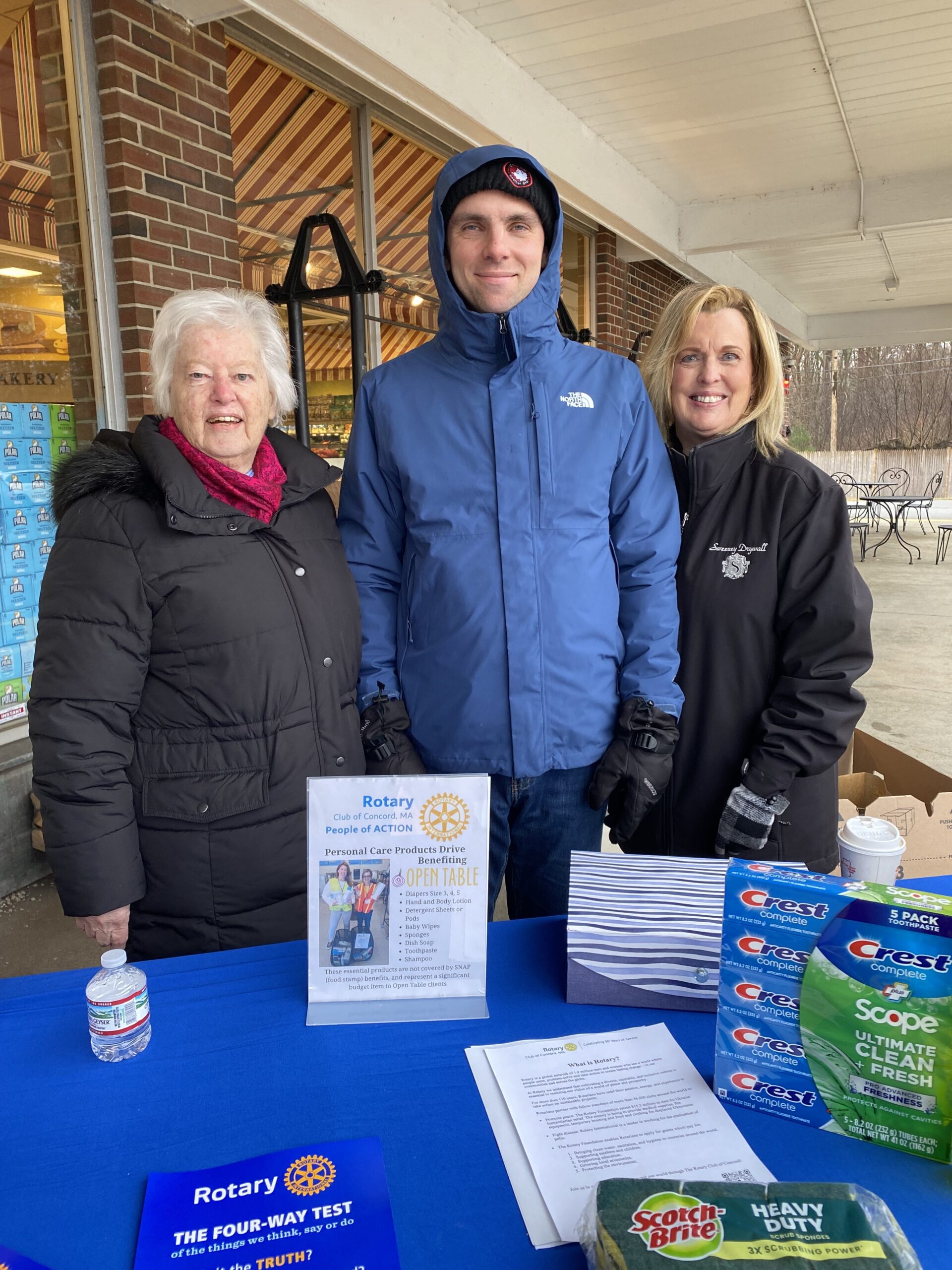 Three Rotarians outside of Crosby's market