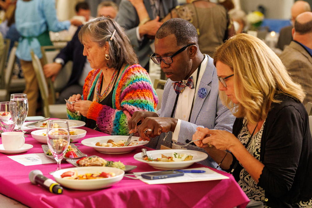 Julia Whiteneck, Chef Lucmann Pierre, and Jeanine Calabria sample the dishes