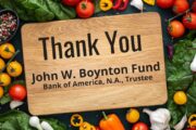 Cutting Board surrounded by fresh produce with black letters saying "Thank you John W. Boynton Fund, Bank of America, N.A, Trustee