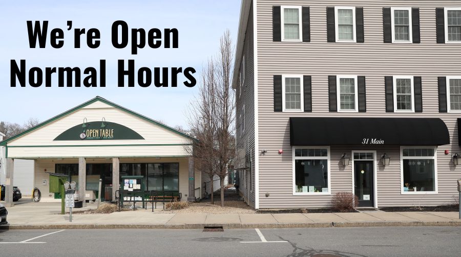 Exterior of 31 and 33 Main St Maynard with words "We're Open Normal Hours" in black