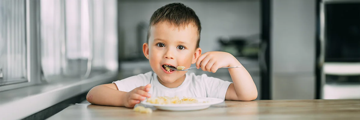 Annual Appeal 2025 - Boy eating pasta